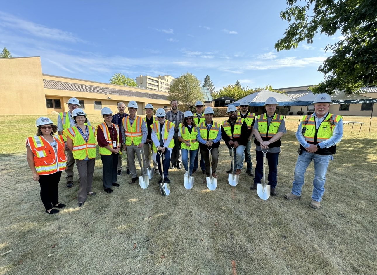 Project team in hard hats and hi-vis vests at a groundbreaking ceremony